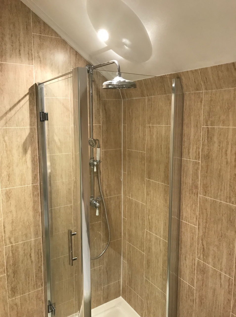 Corner shower enclosure fitted in bathroom designed for the whole family
