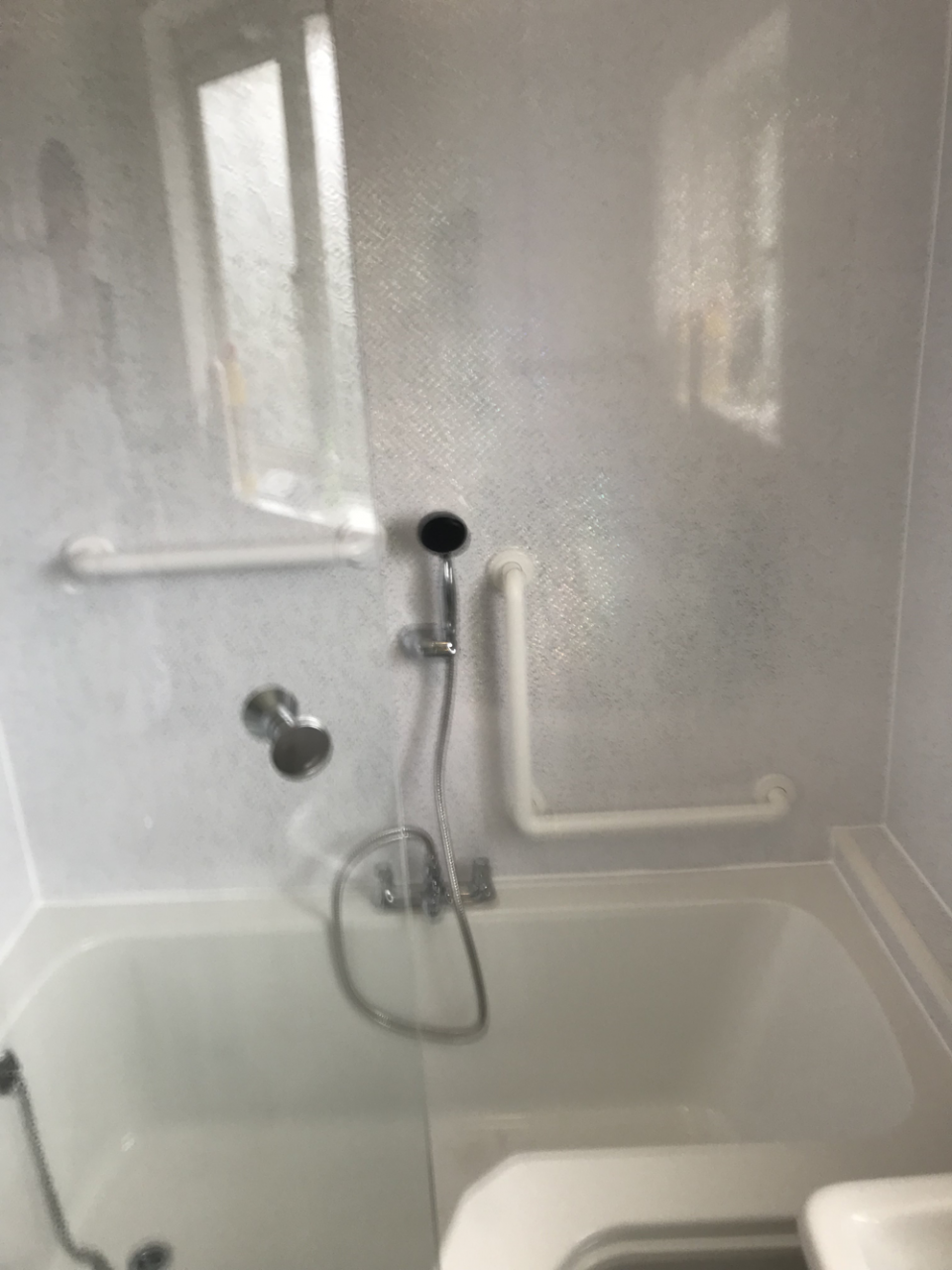 Luxury walk in bath with shower and wall rails to help with mobility
